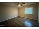 Bedroom with wood-look flooring, ceiling fan, and a window at 3515 E Winchcomb Dr, Phoenix, AZ 85032
