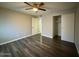 Bedroom with wood-look flooring, ceiling fan, and closet at 3515 E Winchcomb Dr, Phoenix, AZ 85032