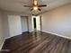 Bedroom with wood-look flooring, ceiling fan, and closet at 3515 E Winchcomb Dr, Phoenix, AZ 85032