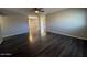 Open-concept living space with gorgeous wood flooring and neutral paint throughout at 3515 E Winchcomb Dr, Phoenix, AZ 85032