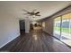 Open living area with wood floors leads to the kitchen and outdoor living space at 3515 E Winchcomb Dr, Phoenix, AZ 85032