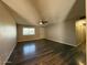 The living room has beautiful wood flooring, a ceiling fan, and plenty of natural light at 3515 E Winchcomb Dr, Phoenix, AZ 85032