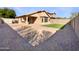 The backyard features a brick patio, artificial turf, a fire pit, and a desert landscape at 3527 N Kashmir --, Mesa, AZ 85215