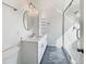 A bright bathroom with a glass shower, dual vanities, updated lighting, and modern fixtures at 3527 N Kashmir --, Mesa, AZ 85215