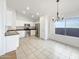 Bright eat-in kitchen features white cabinets, stainless steel appliances, and a modern chandelier at 3527 N Kashmir --, Mesa, AZ 85215