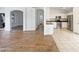 Open floor plan from living area to kitchen includes stainless appliances and white cabinetry at 3527 N Kashmir --, Mesa, AZ 85215