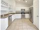 A bright white kitchen with stainless steel appliances, tile floors and ample counter space at 3527 N Kashmir --, Mesa, AZ 85215