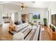 Bright living room features modern furniture, wood floors, ceiling fan, and sliding glass doors to the yard at 3527 N Kashmir --, Mesa, AZ 85215