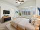 Bright main bedroom with plantation shutters, wood floors, ceiling fan, and a decorative cowhide rug at 3527 N Kashmir --, Mesa, AZ 85215