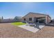 Spacious backyard with gravel, artificial grass lawn, and covered patio seating at 37051 N Rhinelander Dr, San Tan Valley, AZ 85140