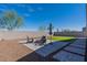 Paver patio featuring an outdoor fire pit and artificial grass lawn at 37051 N Rhinelander Dr, San Tan Valley, AZ 85140