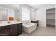 Bright bathroom with double sinks, a soaking tub, and a large window at 37051 N Rhinelander Dr, San Tan Valley, AZ 85140