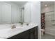 Bathroom featuring double sinks, a large mirror, and a shower with tub at 37051 N Rhinelander Dr, San Tan Valley, AZ 85140