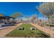 Amenity center offers outdoor games, benches, and patio for socializing, set under a clear blue sky at 37051 N Rhinelander Dr, San Tan Valley, AZ 85140