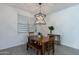 A lovely dining room with lots of light, wood flooring and a hanging light fixture at 37051 N Rhinelander Dr, San Tan Valley, AZ 85140