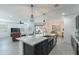A modern kitchen with granite countertops, a large island, and stainless steel appliances at 37051 N Rhinelander Dr, San Tan Valley, AZ 85140