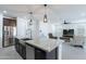 Bright, open kitchen featuring a large island with a sink and stainless steel appliances at 37051 N Rhinelander Dr, San Tan Valley, AZ 85140