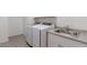 Laundry room featuring white appliances and a utility sink for convenience at 37051 N Rhinelander Dr, San Tan Valley, AZ 85140