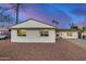 Charming single-story home featuring a xeriscaped front yard with palm trees and a wide driveway at 3723 S Kenneth Pl, Tempe, AZ 85282