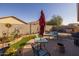 Outdoor patio with seating area and a lush garden at 40802 W Portis Dr, Maricopa, AZ 85138