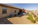 Desert backyard with gravel, artificial grass, a patio, and outdoor furniture at 40802 W Portis Dr, Maricopa, AZ 85138