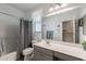 Well-lit bathroom features a shower-tub combination, vanity, and neutral color palette at 40802 W Portis Dr, Maricopa, AZ 85138