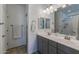 Bright bathroom boasts double sinks, vanity storage, and separate shower area at 40802 W Portis Dr, Maricopa, AZ 85138