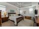 Bedroom with comfortable bed, ceiling fan, and natural light from windows at 40802 W Portis Dr, Maricopa, AZ 85138
