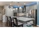 Modern kitchen with gray cabinetry, a large center island, and stainless steel appliances at 40802 W Portis Dr, Maricopa, AZ 85138