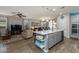Open-concept kitchen with a center island, seamlessly connecting to the living and dining areas at 40802 W Portis Dr, Maricopa, AZ 85138