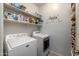 This laundry room offers organized storage and modern appliances at 40802 W Portis Dr, Maricopa, AZ 85138