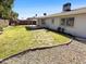 Wide backyard with a covered patio and plenty of grass space at 4119 N 78Th Ave, Phoenix, AZ 85033