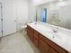 Bright bathroom boasts an elongated vanity with dual sinks, granite countertop, and large mirror at 4127 W Acorn Valley Trl, New River, AZ 85087
