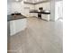 Spacious eat-in kitchen featuring white cabinetry, tile floor, black granite countertop, and modern stainless steel appliances at 4127 W Acorn Valley Trl, New River, AZ 85087