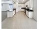 Modern kitchen featuring white cabinets, granite countertops, tile floors, and stainless steel appliances at 4127 W Acorn Valley Trl, New River, AZ 85087
