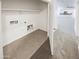 This laundry room with tile flooring has hookups for the washer and dryer at 4127 W Acorn Valley Trl, New River, AZ 85087