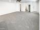 Bright open-concept living room featuring neutral carpet, white walls, and a ceiling fan at 4127 W Acorn Valley Trl, New River, AZ 85087