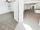 The spacious open layout is visible from this vantage point with gray carpet meeting tile, creating definition at 4127 W Acorn Valley Trl, New River, AZ 85087