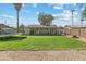 Expansive backyard features lush lawn, covered patio, and mature trees, perfect for outdoor activities at 419 N Valencia Dr, Chandler, AZ 85226