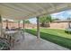 Back patio that overlooks the spacious backyard with a lush green lawn and privacy wall at 419 N Valencia Dr, Chandler, AZ 85226