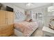 Bright bedroom with a ceiling fan, a window with white blinds, and a cozy bed with a pink comforter at 419 N Valencia Dr, Chandler, AZ 85226