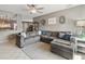 Spacious living room featuring a large sectional sofa, ceiling fan, and a view into the dining area at 419 N Valencia Dr, Chandler, AZ 85226