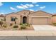 Charming single-story home with desert landscaping and a two-car garage on a sunny day at 42951 W Sandpiper Dr, Maricopa, AZ 85138