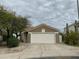 Charming single-story home featuring a two-car garage, desert landscaping, and a tiled roof at 4402 E Creosote Dr, Cave Creek, AZ 85331