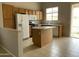 Bright kitchen with wood cabinets, an island, tile floors, and access to backyard at 4402 E Creosote Dr, Cave Creek, AZ 85331