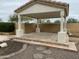 Covered outdoor patio with stone flooring and stucco pillars, perfect for entertaining and enjoying the serene outdoor space at 4402 E Creosote Dr, Cave Creek, AZ 85331