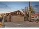 A single-story home with desert landscaping featuring a two-car garage, RV parking and stacked stone facade at 446 W Sereno Dr, Gilbert, AZ 85233