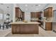 Kitchen featuring granite countertops, stainless steel appliances, dark wood cabinetry, and an island at 446 W Sereno Dr, Gilbert, AZ 85233