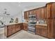 Updated kitchen featuring stainless steel appliances, tile floors, granite countertops, and stylish cabinetry at 446 W Sereno Dr, Gilbert, AZ 85233
