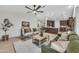 Spacious living room with tile floors, ceiling fan, and seamless flow into the kitchen at 446 W Sereno Dr, Gilbert, AZ 85233